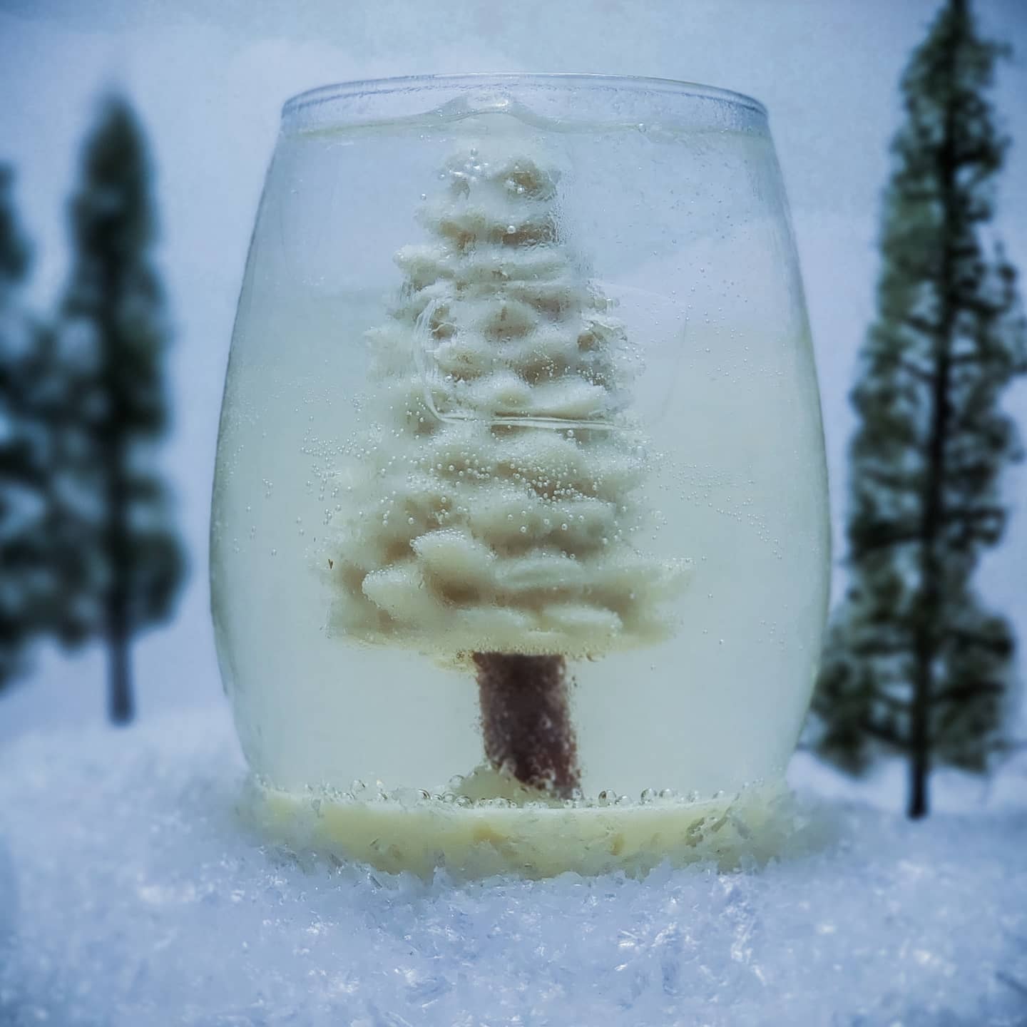 Clear vodka drink with a tree inside the glass